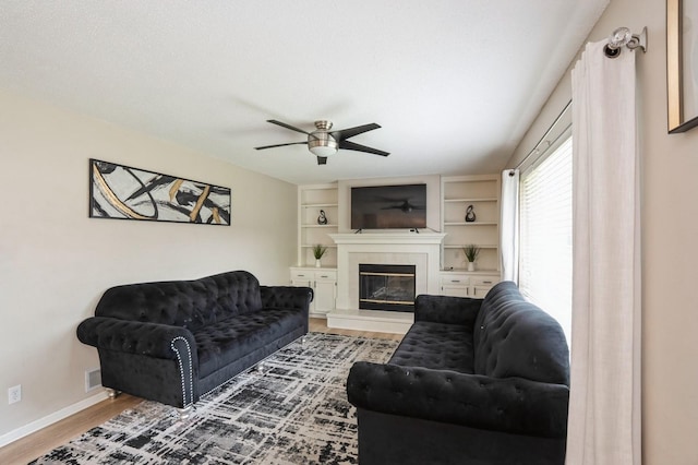 681 63rd St, West Des Moines, IA 50266 - living room with ceiling fan, wood finished floors, and a glass covered fireplace