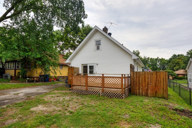 816 Boyd St, Des Moines, IA 50316 - rear view of house with a chimney and a wooden deck