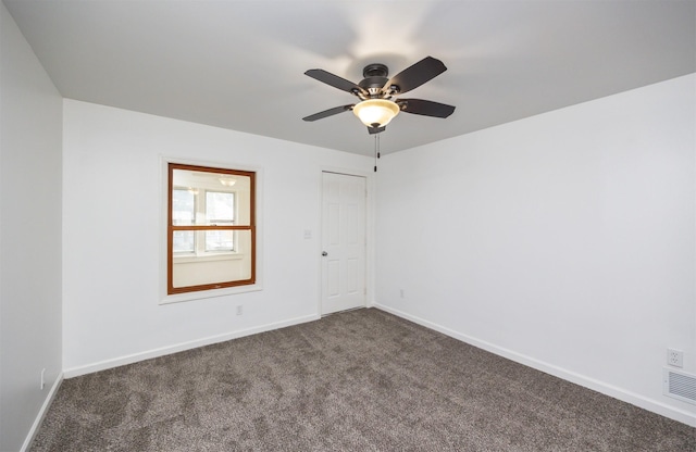 816 Boyd St, Des Moines, IA 50316 - empty room with dark carpet and a ceiling fan
