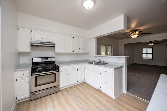 816 Boyd St, Des Moines, IA 50316 - kitchen featuring gas range, under cabinet range hood, a peninsula, and light countertops
