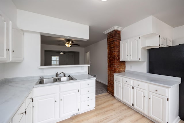 816 Boyd St, Des Moines, IA 50316 - kitchen featuring a peninsula, light wood-style floors, ceiling fan, light countertops, and freestanding refrigerator