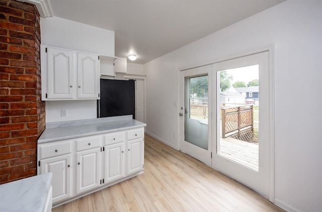 816 Boyd St, Des Moines, IA 50316 - kitchen featuring light countertops, light wood-style flooring, and white cabinetry