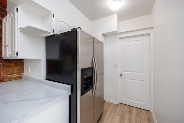 816 Boyd St, Des Moines, IA 50316 - kitchen with stainless steel refrigerator with ice dispenser, white cabinetry, light countertops, light wood-style flooring, and open shelves