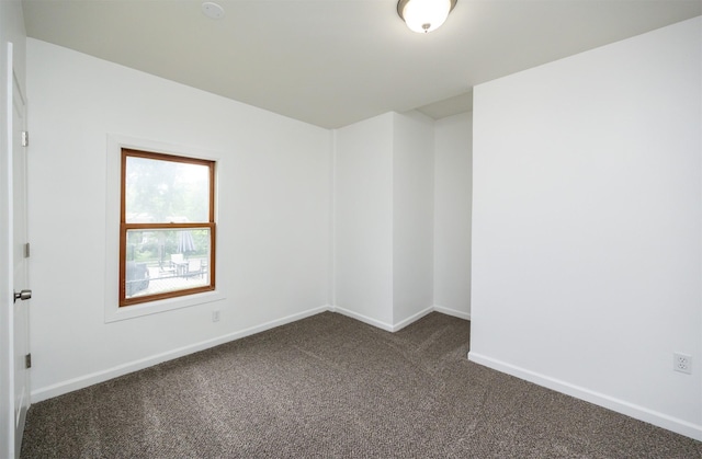 816 Boyd St, Des Moines, IA 50316 - unfurnished room featuring dark colored carpet and baseboards