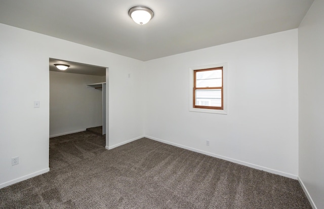 816 Boyd St, Des Moines, IA 50316 - unfurnished bedroom with dark colored carpet and baseboards
