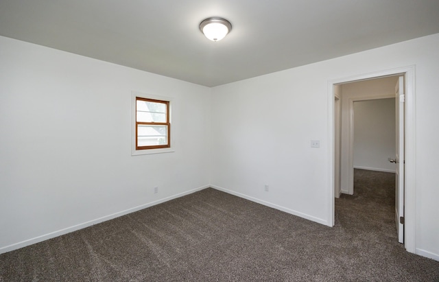 816 Boyd St, Des Moines, IA 50316 - empty room with dark colored carpet and baseboards