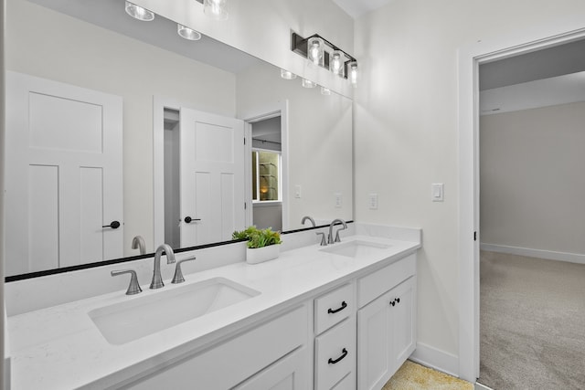2309 NW 29th St, Ankeny, IA 50023 - bathroom featuring double vanity and baseboards