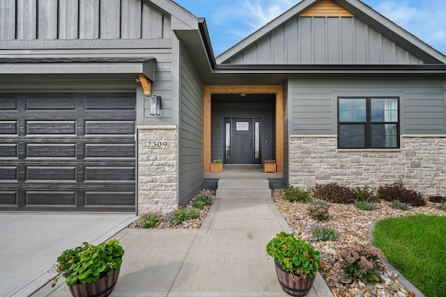 2309 NW 29th St, Ankeny, IA 50023 - property entrance with board and batten siding, stone siding, and an attached garage