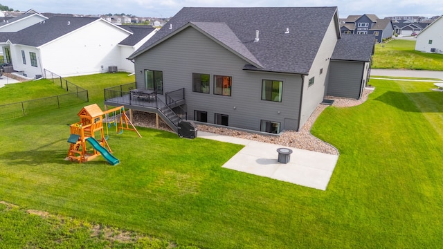2309 NW 29th St, Ankeny, IA 50023 - rear view of property featuring a playground, roof with shingles, a fenced backyard, a residential view, and a wooden deck