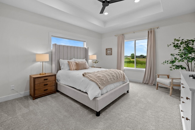 2309 NW 29th St, Ankeny, IA 50023 - bedroom featuring multiple windows, light carpet, a raised ceiling, recessed lighting, and a ceiling fan