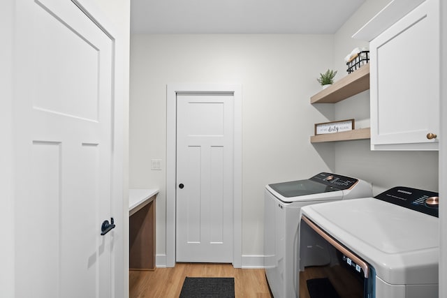 2309 NW 29th St, Ankeny, IA 50023 - laundry room with cabinet space, washer and clothes dryer, and light wood-style floors