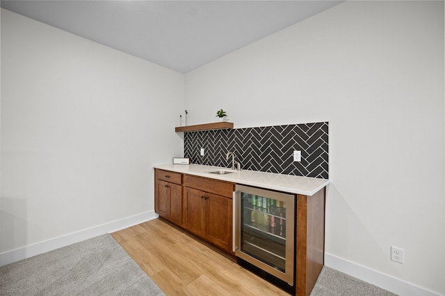 2309 NW 29th St, Ankeny, IA 50023 - indoor wet bar with wine cooler, tasteful backsplash, and light wood-type flooring