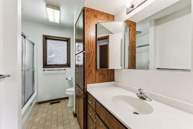 6542 Washington Ave, Windsor Heights, IA 50324 - full bath with a textured ceiling, vanity, tile patterned floors, and enclosed tub / shower combo