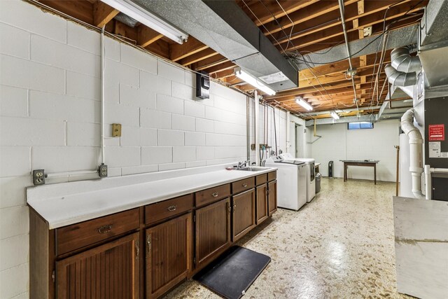 6542 Washington Ave, Windsor Heights, IA 50324 - laundry area with independent washer and dryer, cabinet space, and concrete block wall