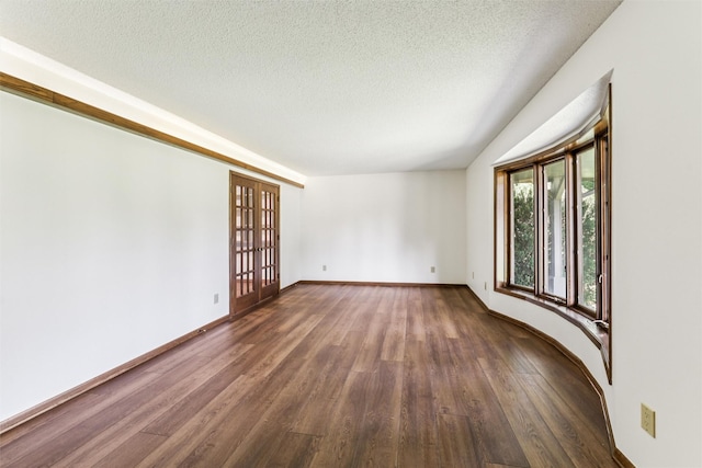 6542 Washington Ave, Windsor Heights, IA 50324 - empty room featuring dark wood-style floors and a textured ceiling