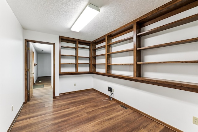 6542 Washington Ave, Windsor Heights, IA 50324 - unfurnished room featuring a textured ceiling and dark wood finished floors