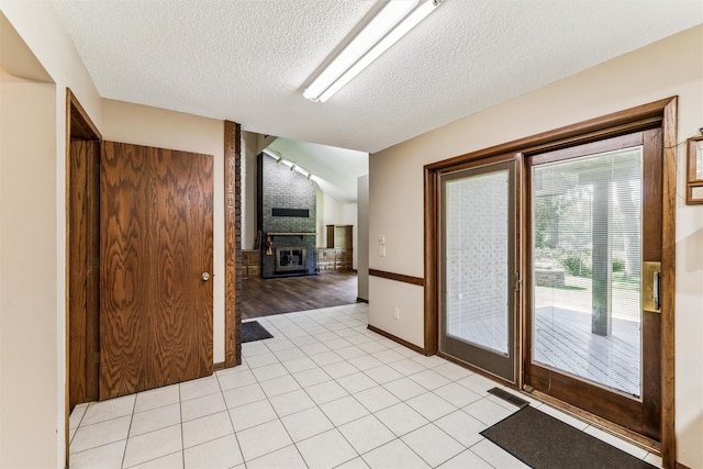 6542 Washington Ave, Windsor Heights, IA 50324 - unfurnished room with a textured ceiling, light tile patterned floors, and a fireplace