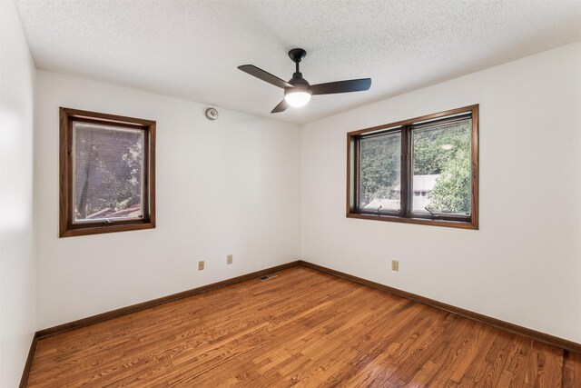 6542 Washington Ave, Windsor Heights, IA 50324 - empty room featuring light wood finished floors, a ceiling fan, and a textured ceiling