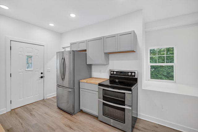 1124 13th St, Des Moines, IA 50314 - kitchen with stainless steel appliances, gray cabinetry, light wood-type flooring, and recessed lighting