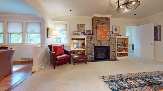 3827 Carpenter Ave, Des Moines, IA 50311 - living area with a fireplace, crown molding, and arched walkways