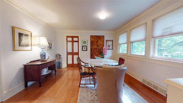 3827 Carpenter Ave, Des Moines, IA 50311 - dining space featuring light wood-style flooring and crown molding