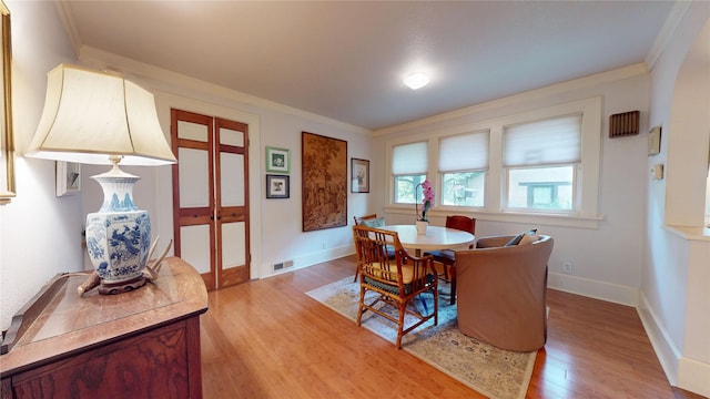 3827 Carpenter Ave, Des Moines, IA 50311 - dining space with ornamental molding, light wood finished floors, and french doors