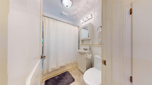 3827 Carpenter Ave, Des Moines, IA 50311 - bathroom with tile patterned floors, vanity, and shower / bath combo with shower curtain