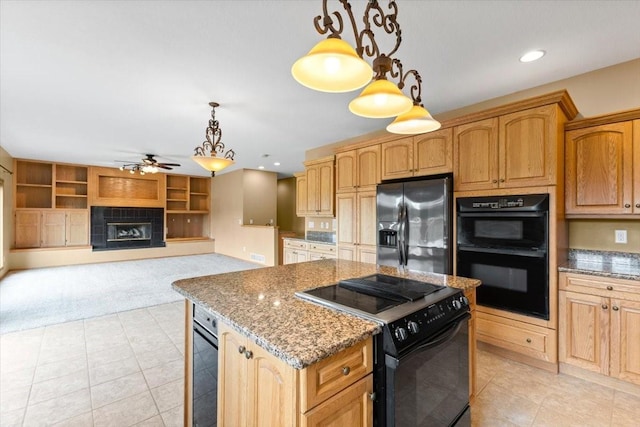 704 SW Coventry Cir, Ankeny, IA 50023 - kitchen featuring black appliances, ceiling fan, light stone countertops, light colored carpet, and a tiled fireplace