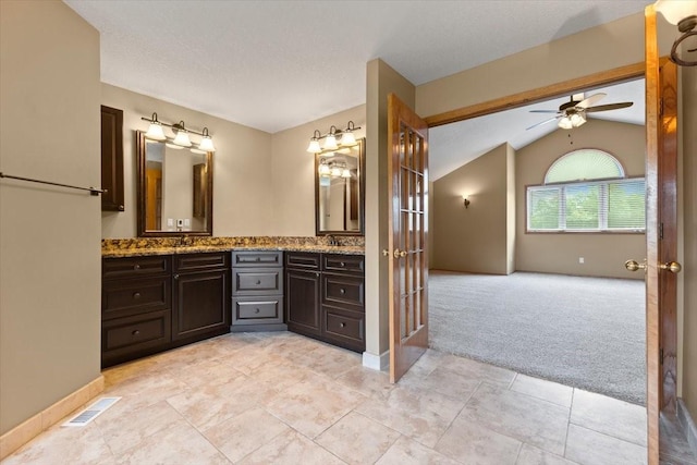 704 SW Coventry Cir, Ankeny, IA 50023 - bathroom featuring double vanity, ceiling fan, vaulted ceiling, and french doors