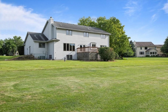 704 SW Coventry Cir, Ankeny, IA 50023 - back of property featuring a chimney, a lawn, and a deck