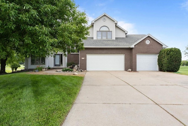 704 SW Coventry Cir, Ankeny, IA 50023 - view of front of property featuring driveway, a front lawn, roof with shingles, and brick siding