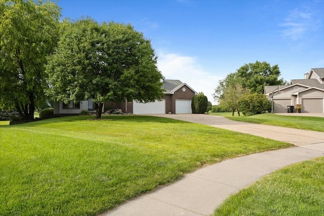 704 SW Coventry Cir, Ankeny, IA 50023 - view of property hidden behind natural elements with a garage and a front lawn