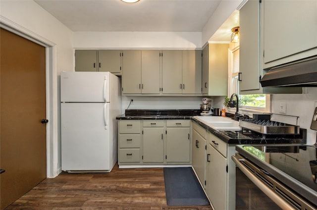 4207 Madison Ave, Des Moines, IA 50310 - kitchen featuring freestanding refrigerator, stainless steel electric stove, dark countertops, dark wood-style flooring, and under cabinet range hood