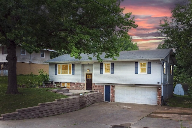 1018 S 5th St, Knoxville, IA 50138 - raised ranch with driveway, a garage, a front lawn, and brick siding