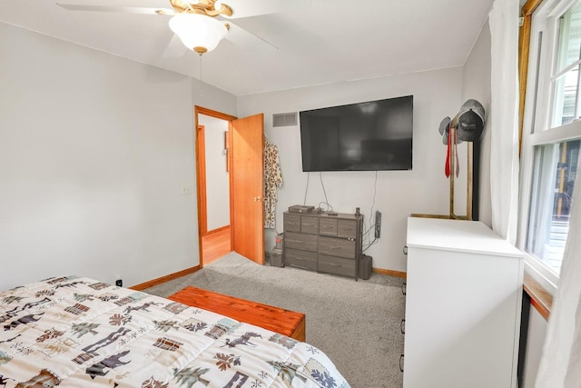 1018 S 5th St, Knoxville, IA 50138 - carpeted bedroom featuring baseboards and a ceiling fan