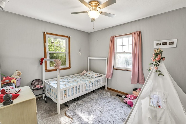 1018 S 5th St, Knoxville, IA 50138 - bedroom with carpet, multiple windows, and ceiling fan
