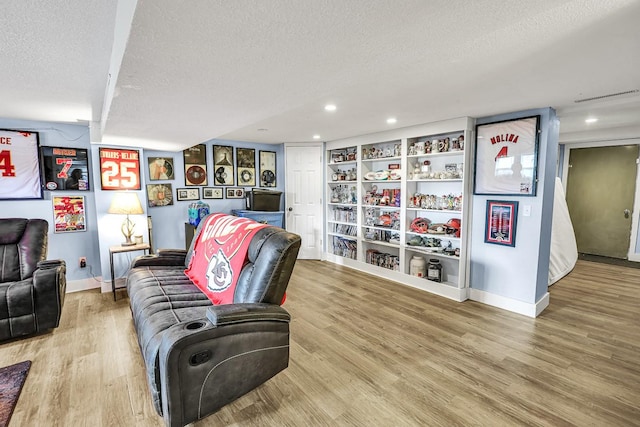 1018 S 5th St, Knoxville, IA 50138 - living area with a textured ceiling, wood finished floors, and recessed lighting