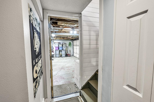 1018 S 5th St, Knoxville, IA 50138 - doorway to outside with unfinished concrete floors and a textured wall