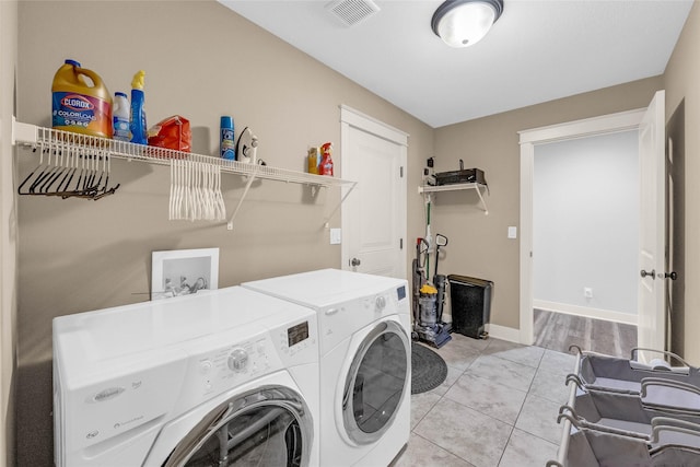 2501 NE Ewing Ct, Grimes, IA 50111 - laundry area featuring washer and clothes dryer and light tile patterned floors
