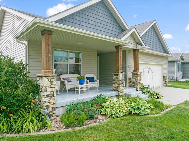 2501 NE Ewing Ct, Grimes, IA 50111 - view of front facade featuring a porch, a garage, concrete driveway, and roof with shingles