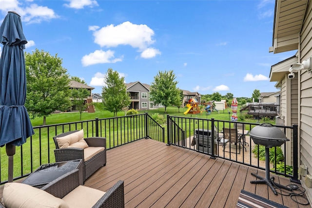2501 NE Ewing Ct, Grimes, IA 50111 - wooden deck with a playground, an outdoor living space, a lawn, a residential view, and area for grilling