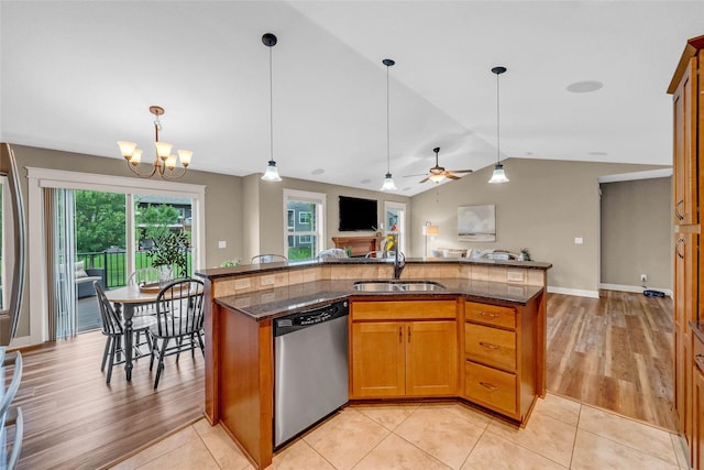 2501 NE Ewing Ct, Grimes, IA 50111 - kitchen with appliances with stainless steel finishes, open floor plan, dark stone countertops, pendant lighting, and vaulted ceiling