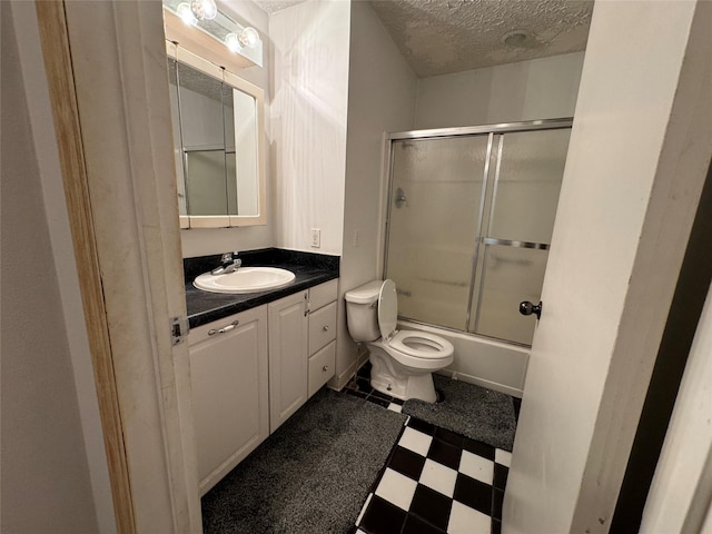3419 E 37th St, Des Moines, IA 50317 - full bath featuring tile patterned floors, vanity, a textured ceiling, and shower / bath combination with glass door