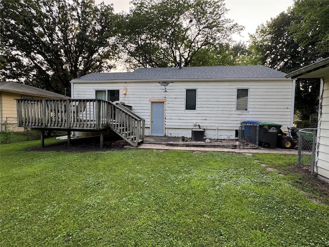 3419 E 37th St, Des Moines, IA 50317 - rear view of property with a deck, a lawn, and a shingled roof