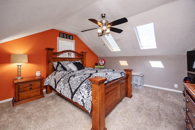 524 1st St, West Des Moines, IA 50265 - bedroom featuring a skylight, light carpet, lofted ceiling, and ceiling fan