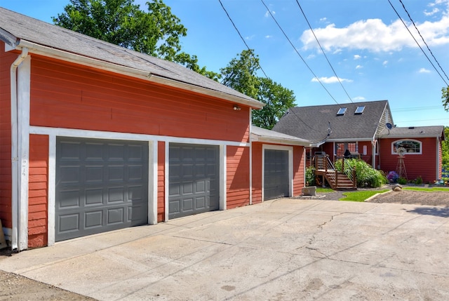 524 1st St, West Des Moines, IA 50265 - view of front of property featuring a garage, driveway, and a shingled roof
