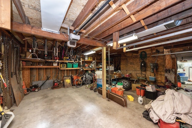 524 1st St, West Des Moines, IA 50265 - garage featuring a garage door opener and a workshop area