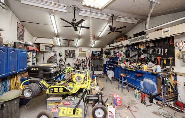 524 1st St, West Des Moines, IA 50265 - garage featuring a ceiling fan, a workshop area, and an AC wall unit