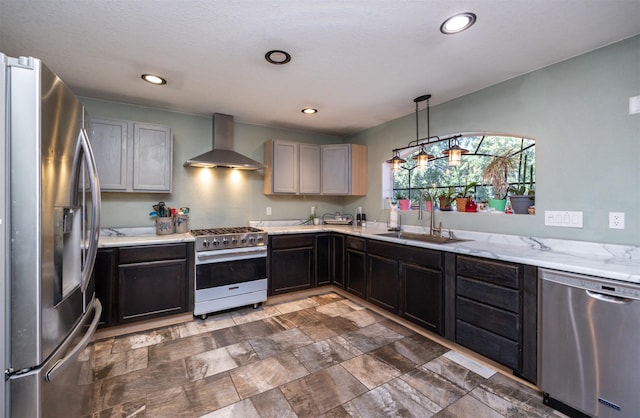 524 1st St, West Des Moines, IA 50265 - kitchen with appliances with stainless steel finishes, wall chimney range hood, hanging light fixtures, recessed lighting, and dark stone finish floors