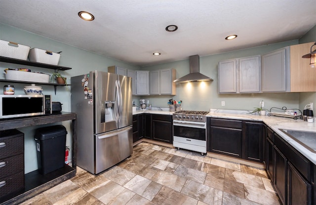 524 1st St, West Des Moines, IA 50265 - kitchen with stainless steel appliances, wall chimney range hood, and recessed lighting